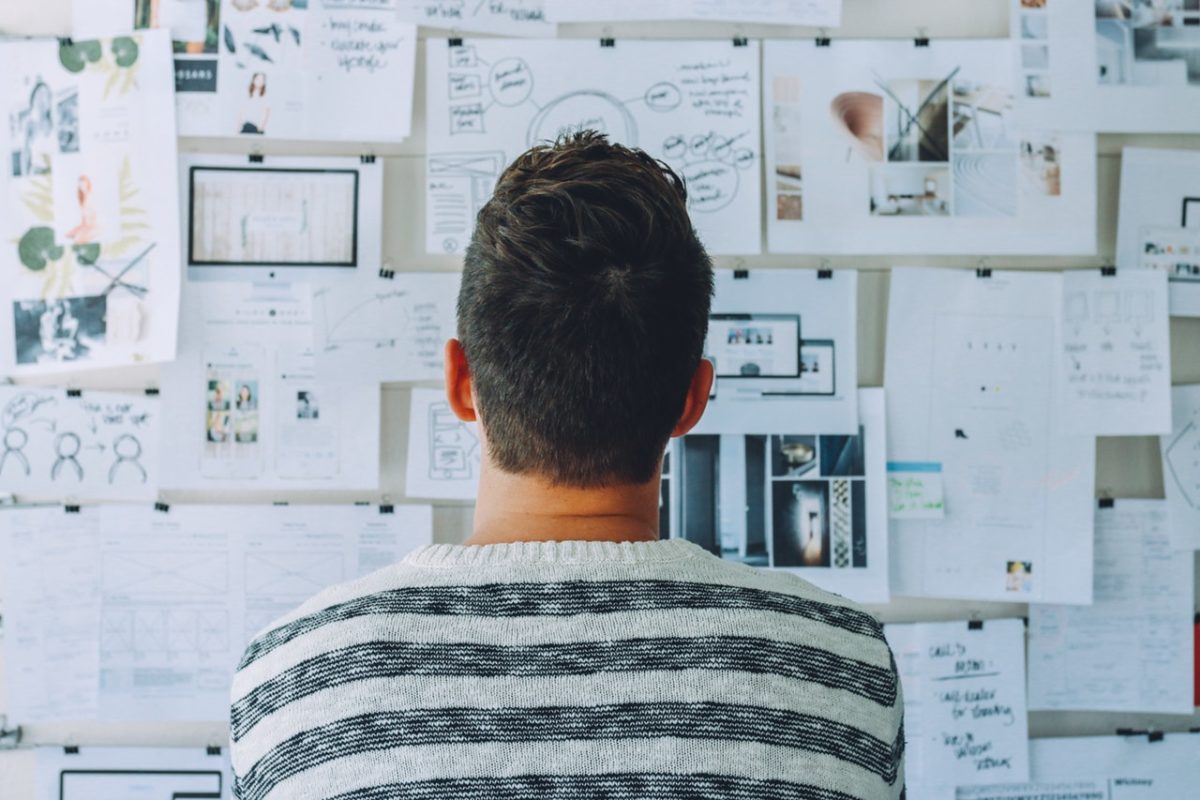 a man staring at a notice board